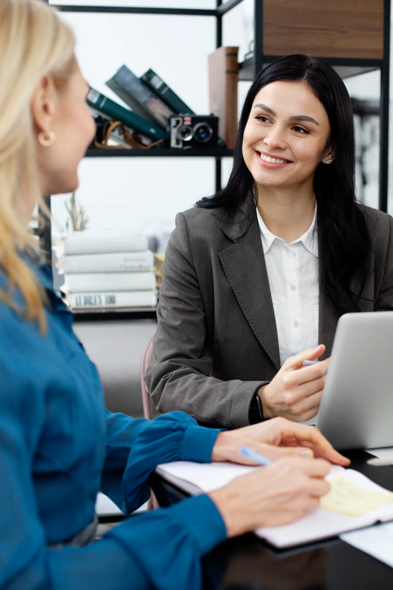 Businesswoman smiling with laptop in meeting